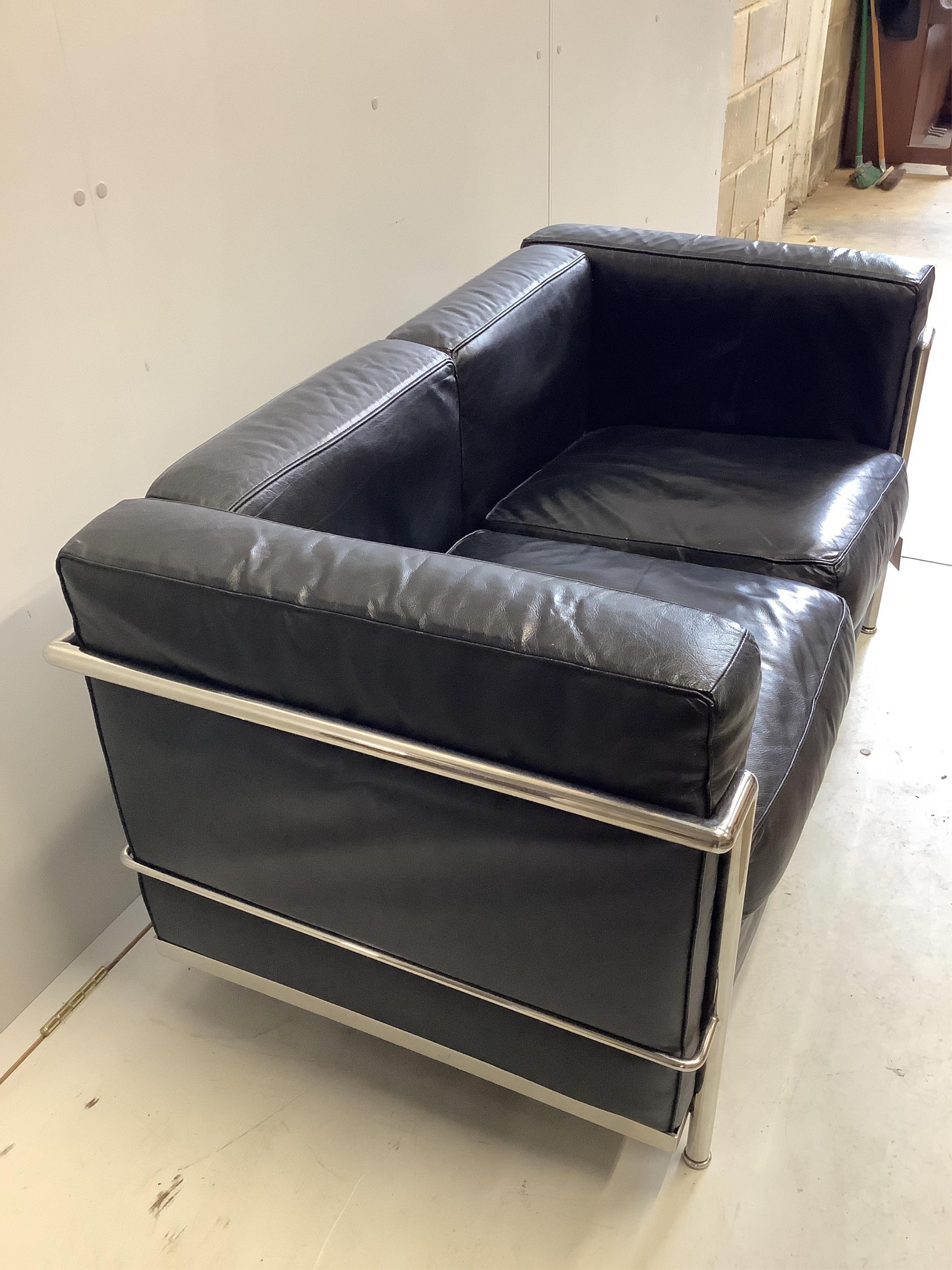 A Le Corbusier style two seater settee, width 130cm, depth 70cm, height 64cm. Condition - fair